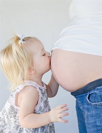 pregnant women kissing - Little Girl Kissing New Sibling to Be Stock Photo - Budget Royalty-Free & Subscription, Code: 400-04587776