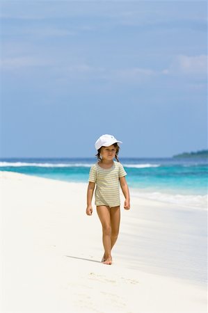 A beautiful young girl walking on the ocean beach in Maldives Stock Photo - Budget Royalty-Free & Subscription, Code: 400-04587931