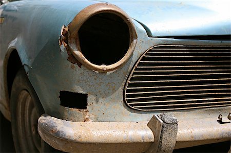 The front grill and headlight of an old car in need of restoration and repairs Stock Photo - Budget Royalty-Free & Subscription, Code: 400-04589486