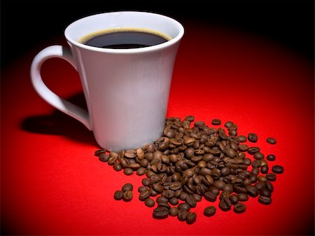 A cup of tasty coffee and some coffee beans aside. Stock Photo - Budget Royalty-Free & Subscription, Code: 400-04589590