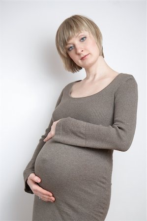 simsearch:400-04396054,k - full-body portrait of a pregnant woman in a dark beige dress Stock Photo - Budget Royalty-Free & Subscription, Code: 400-04589797