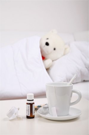 pediatric nursing - Teddybear lying in bed with cup of tea and medicine Stock Photo - Budget Royalty-Free & Subscription, Code: 400-04583200