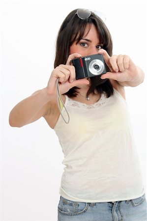 Half body view of lovely young woman taking a photo with a small black camera. Isolated on white background. Stock Photo - Budget Royalty-Free & Subscription, Code: 400-04597822