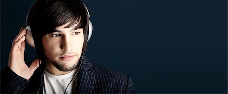 simsearch:400-05748462,k - Young Man listening to music with headphones Stock Photo - Budget Royalty-Free & Subscription, Code: 400-04604553