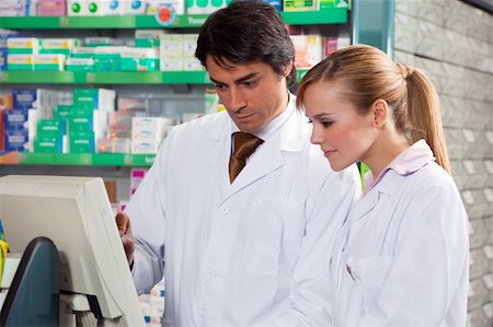 simsearch:400-04106195,k - portrait of two pharmacists looking at computer monitor Stock Photo - Budget Royalty-Free & Subscription, Code: 400-04604809