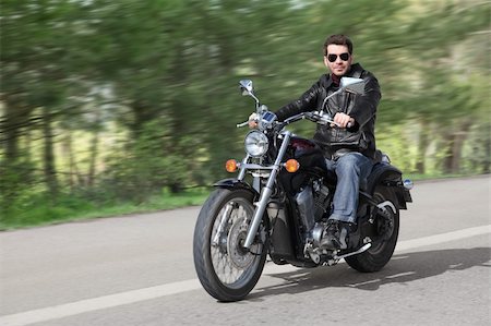 simsearch:400-05017762,k - Young rider driving his cruiser-type motorcycle on the country road. Stock Photo - Budget Royalty-Free & Subscription, Code: 400-04604864