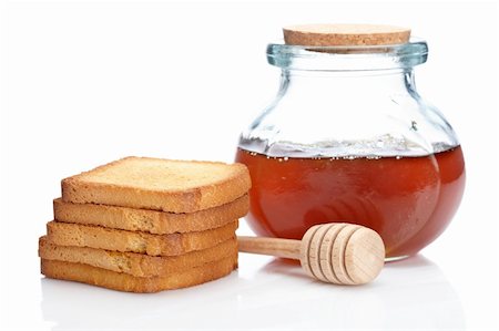 simsearch:400-05135233,k - Honey jar, pile of toasts and wooden drizzler, reflected on white background Foto de stock - Super Valor sin royalties y Suscripción, Código: 400-04607143
