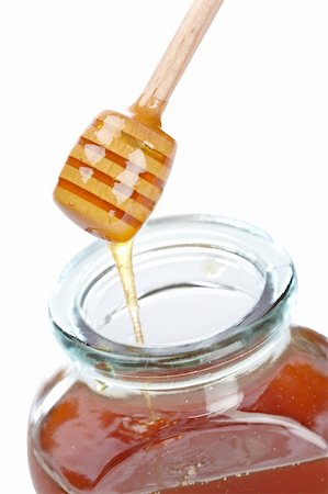 simsearch:400-05135233,k - Pouring honey on glass jar isolated on white background. Shallow depth of field Foto de stock - Super Valor sin royalties y Suscripción, Código: 400-04607544