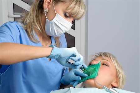 dentist at work, installation of rubber dam (Kofferdam) Stock Photo - Budget Royalty-Free & Subscription, Code: 400-04600974