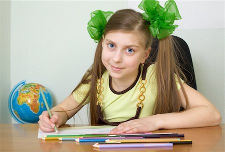 The girl sitting at a table with color pencils Stock Photo - Budget Royalty-Free & Subscription, Code: 400-04600989