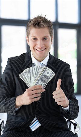 simsearch:400-04408371,k - Young Businessman holding dollars in his hands Stock Photo - Budget Royalty-Free & Subscription, Code: 400-04601595