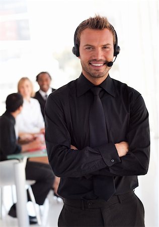 simsearch:400-03933798,k - Young Businessman with headset on in office environment Stock Photo - Budget Royalty-Free & Subscription, Code: 400-04602777