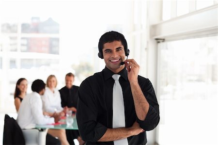 simsearch:400-03933798,k - Young Businessman talking on a headset Stock Photo - Budget Royalty-Free & Subscription, Code: 400-04602790