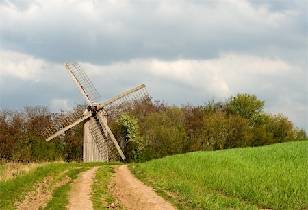 simsearch:400-05319608,k - The old windmill to stand on a green field near wood Stock Photo - Budget Royalty-Free & Subscription, Code: 400-04603063