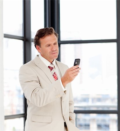 phone one person adult smile elderly - Portrait of a mature businessman sending a text on a mobile phone Stock Photo - Budget Royalty-Free & Subscription, Code: 400-04614551
