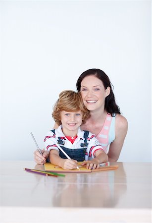 simsearch:400-05749563,k - Mother and son writing at home and smiling to the camera Stock Photo - Budget Royalty-Free & Subscription, Code: 400-04614625