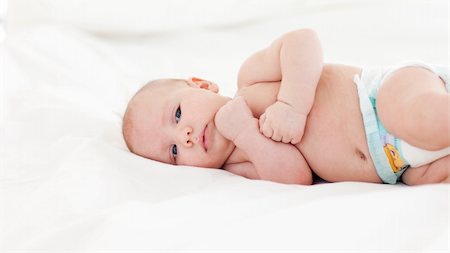 Beautiful newborn baby lying in bed Stock Photo - Budget Royalty-Free & Subscription, Code: 400-04614634