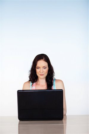 simsearch:400-04281575,k - Attractive serious woman focused on her laptop with copy-space Stock Photo - Budget Royalty-Free & Subscription, Code: 400-04615965