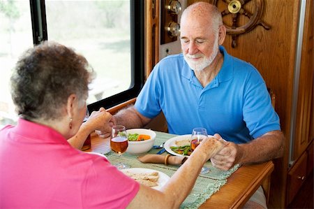 simsearch:400-04208630,k - Christian senior couple in their motor home, saying grace over their meal. Stock Photo - Budget Royalty-Free & Subscription, Code: 400-04618010