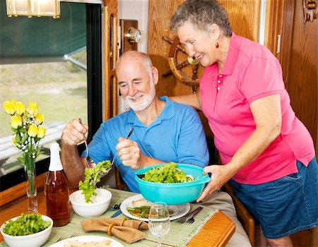 simsearch:400-04208630,k - Senior woman serving salad to her husband as they prepare to eat lunch in their motor home. Stock Photo - Budget Royalty-Free & Subscription, Code: 400-04618013