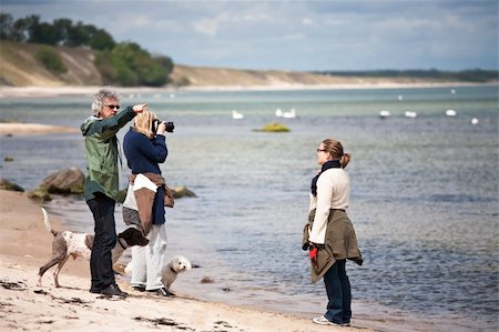 photographers taking pictures of models - Photographer, model and director at a shoot on the beach Stock Photo - Budget Royalty-Free & Subscription, Code: 400-04618369