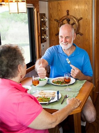 simsearch:400-04208630,k - Senior man gives his wife a big thumbs up for the delicious dinner she made in their motor home. Stock Photo - Budget Royalty-Free & Subscription, Code: 400-04618403