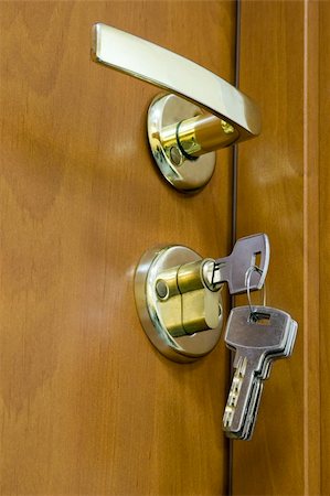 simsearch:400-04617631,k - The sheaf of keys is inserted into a keyhole near to the door handle Stock Photo - Budget Royalty-Free & Subscription, Code: 400-04619634