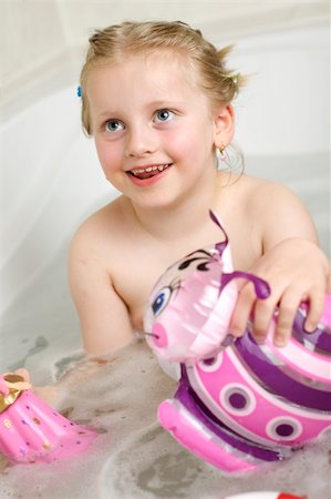 Child sitting in a bath tube and plays with her toys Stock Photo - Budget Royalty-Free & Subscription, Code: 400-04610119