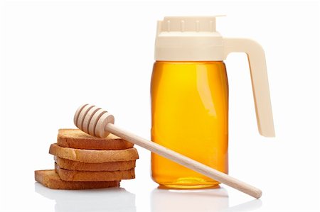 simsearch:400-05135233,k - Honey pitcher, wooden drizzler and pile of toasts, reflected on white background Foto de stock - Super Valor sin royalties y Suscripción, Código: 400-04610335