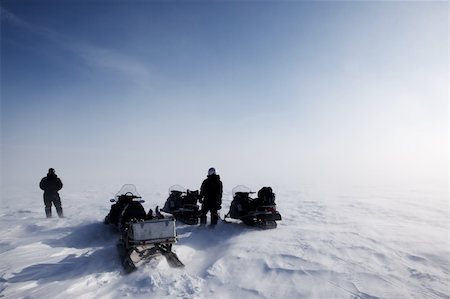 A blowing snow landscape with three snowmobiles on an expedition Stock Photo - Budget Royalty-Free & Subscription, Code: 400-04610584