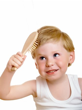 a beautiful little boy, combs his hair Stock Photo - Budget Royalty-Free & Subscription, Code: 400-04611118