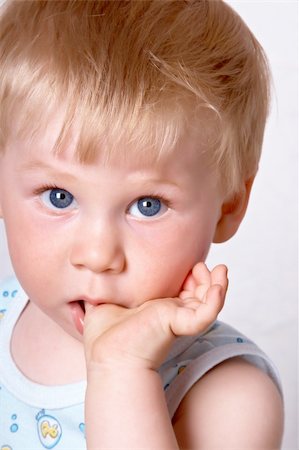 shy baby - Portrait of the blond little boy on a background Stock Photo - Budget Royalty-Free & Subscription, Code: 400-04612048