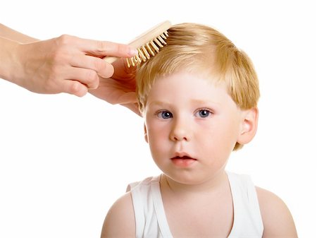 Female hands brush the little boy Stock Photo - Budget Royalty-Free & Subscription, Code: 400-04612068