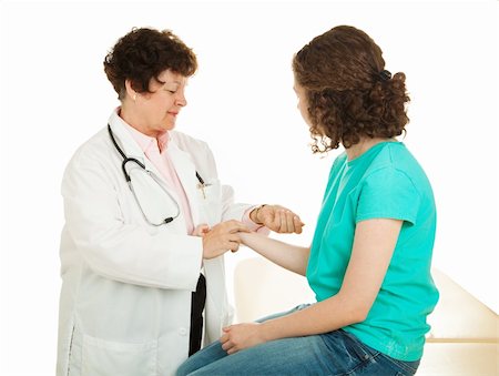 Teen girl has her pulse taken by a caring female doctor.  Isolated. Photographie de stock - Aubaine LD & Abonnement, Code: 400-04612967