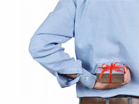 Young man hiding a gift box behind his back. Stock Photo - Budget Royalty-Free & Subscription, Code: 400-04613419
