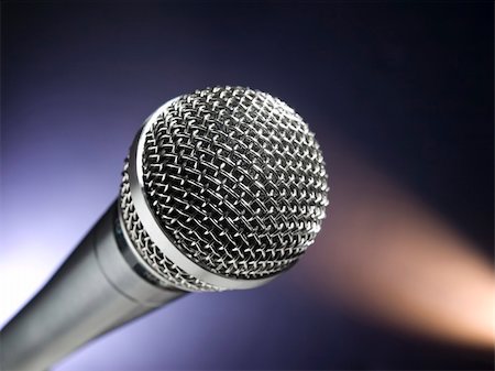 simsearch:400-06954069,k - A dynamic microphone on stage. Color spot lights as background. Photographie de stock - Aubaine LD & Abonnement, Code: 400-04613420