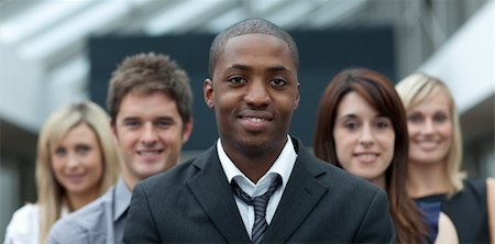 Afro-American young businessman smiling at the camera with his team Stock Photo - Budget Royalty-Free & Subscription, Code: 400-04624254