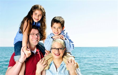 Happy family having fun giving shoulder rides Stock Photo - Budget Royalty-Free & Subscription, Code: 400-04625100