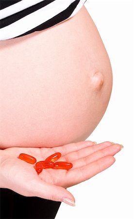 simsearch:400-04396054,k - belly of pregnant woman with capsules in hand isolated on white Stock Photo - Budget Royalty-Free & Subscription, Code: 400-04625831