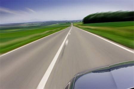 Zooming fast moving car travelling on the road Stock Photo - Budget Royalty-Free & Subscription, Code: 400-04627392