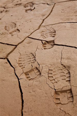 environmental impact - Environmental concept shot showing bootprints going across cracked dry earth in dried up lake bed or riverbed. Stock Photo - Budget Royalty-Free & Subscription, Code: 400-04621972