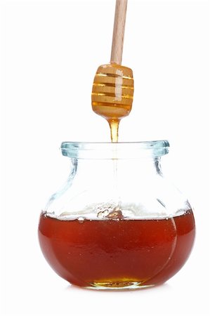 simsearch:400-05135233,k - Pouring honey on glass jar isolated on white background. Shallow depth of field Foto de stock - Super Valor sin royalties y Suscripción, Código: 400-04622352