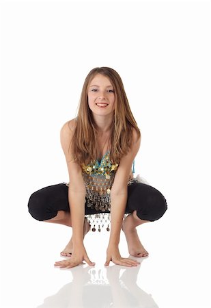 Young Caucasian belly dancing girl in beautiful decorated clothes on white background and reflective floor. Not isolated Stock Photo - Budget Royalty-Free & Subscription, Code: 400-04623098