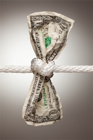Wrinkled American Dollar Tied Up in Rope. Stock Photo - Budget Royalty-Free & Subscription, Code: 400-04623257