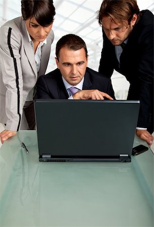 simsearch:400-04113367,k - team of three business people , looking at the monitor of a laptop Stock Photo - Budget Royalty-Free & Subscription, Code: 400-04634239