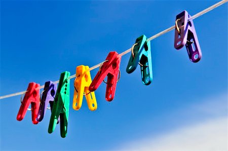 simsearch:400-04263617,k - Colorful clothes pegs on line against blue sky Photographie de stock - Aubaine LD & Abonnement, Code: 400-04636768