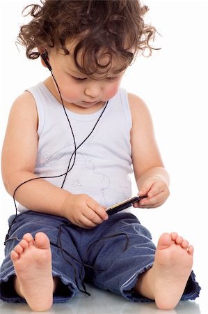 simsearch:400-04638236,k - Child with mp 3 player,isolated on a white background. Photographie de stock - Aubaine LD & Abonnement, Code: 400-04637187