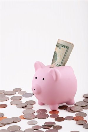 simsearch:400-06077471,k - Pink Piggy Bank isolated on white background with coins and has a 20 dollar bill sticking out Stock Photo - Budget Royalty-Free & Subscription, Code: 400-04630180