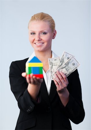 simsearch:400-04663994,k - Woman holding a house and dollars Stock Photo - Budget Royalty-Free & Subscription, Code: 400-04630914