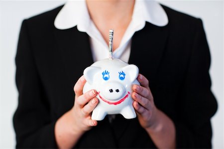 simsearch:400-05718324,k - Young Woman Holding a piggy bank with dollars in it Stock Photo - Budget Royalty-Free & Subscription, Code: 400-04630927